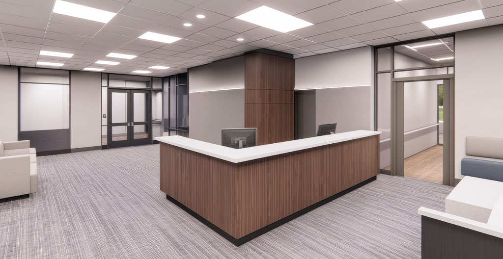 Espace d'accueil professionnel étroit avec mobilier surdimensionné gênant le passage